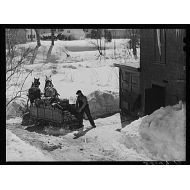 HistoricalFindings Photo: Unloading Stove Wood from sled woodshed. Woodstock,Vermont