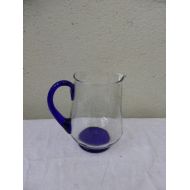 JECHINEPOURVOUS PICHET CARAFE in transparent glass with handle and vintage blue background