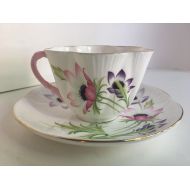 /Teatimememories Mid century Shelley tea cup and saucer. Delicate Shelley teacup with pink handle. Pink and lavender floral pattern. Rare Shelley teacup.