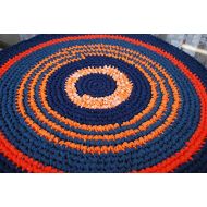 La Rugs Boutique Orange and blue handmade circle rug I crocheted it to have the lines run around the entire piece. It is reversible. Old unwanted sheets and made them into something new. Rugs are m
